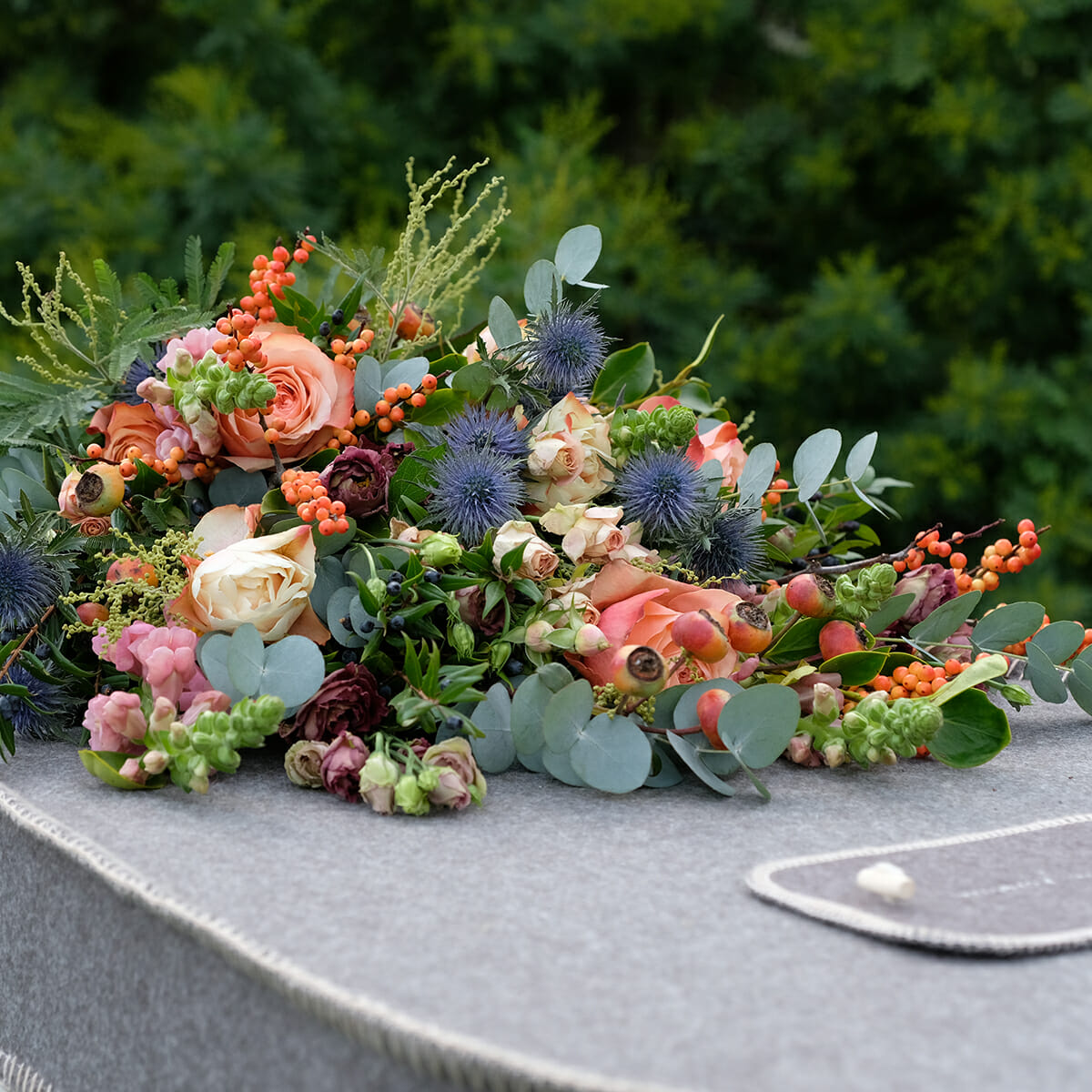 Gallery flower spray on grey coffin